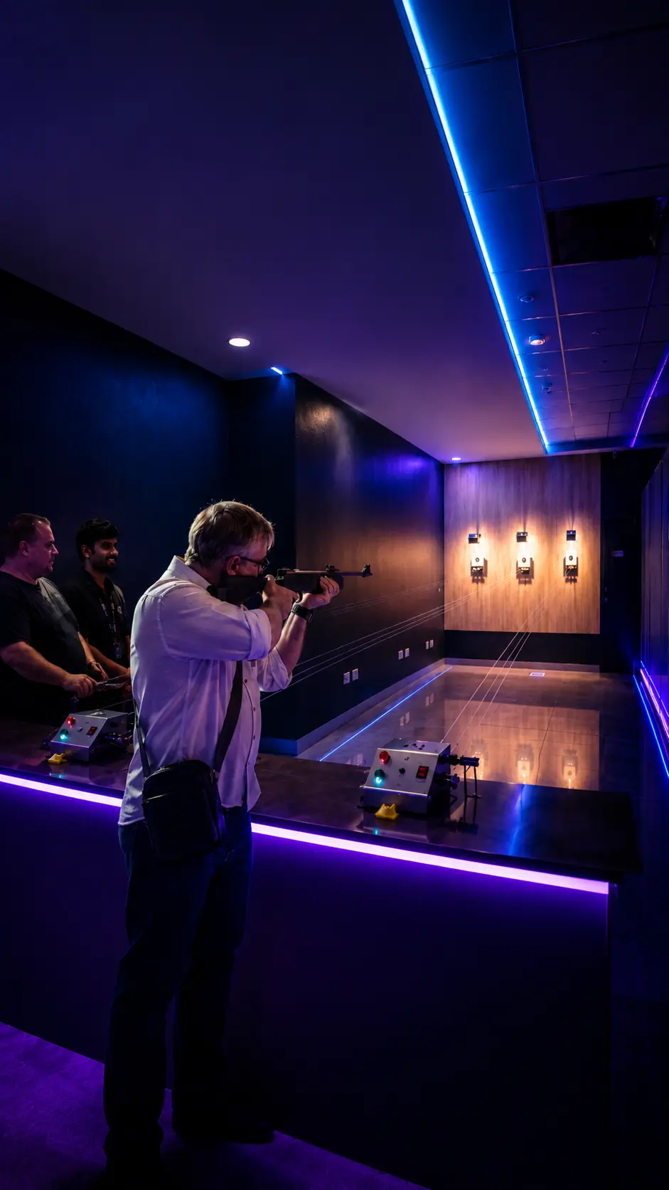 Two friends smiling at indoor air gun shooting range at Game Xtreme Hyderabad
