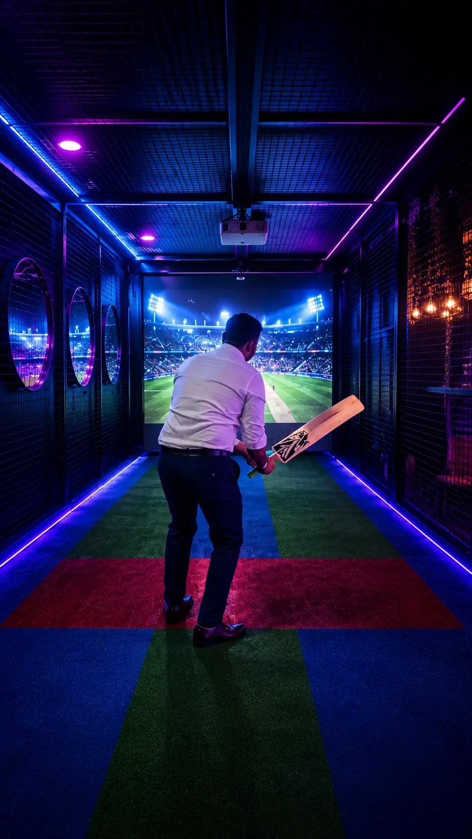 Player batting in cricket simulator facing projected stadium at Game Xtreme